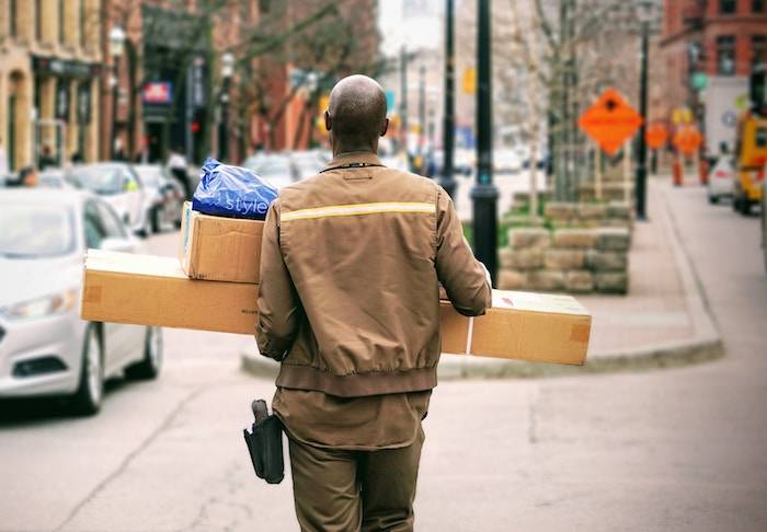 web1_maarten-van-den-heuvel-246398 A man carrying packages