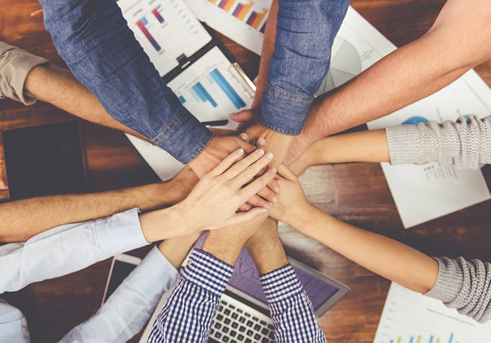 web1_employee-hands_shutterstock-2- teamwork